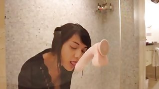 Hot asian uses a dildo in the shower