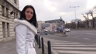 Sexy brunette in the streets right to the studio for a naked photo shoot